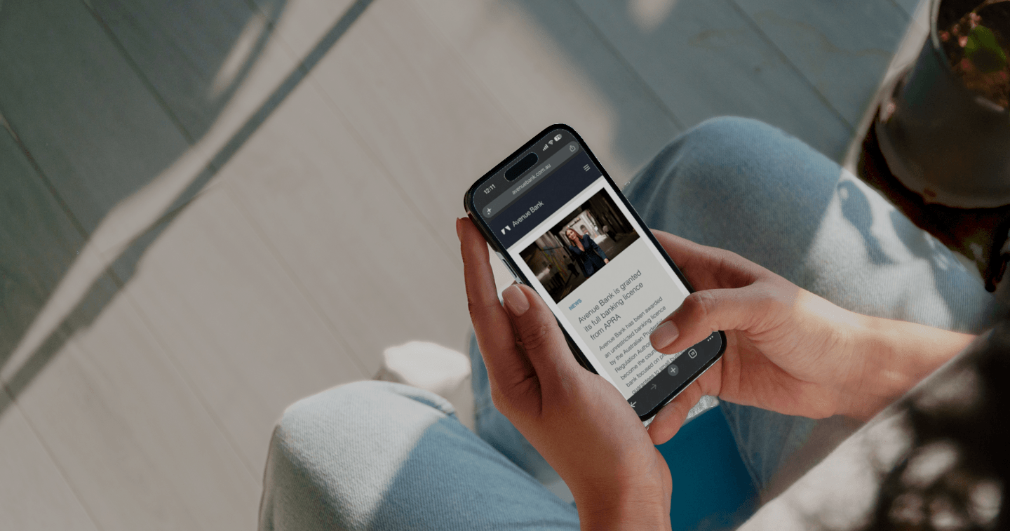 Close up of phone opened onto an Avenue Bank news article